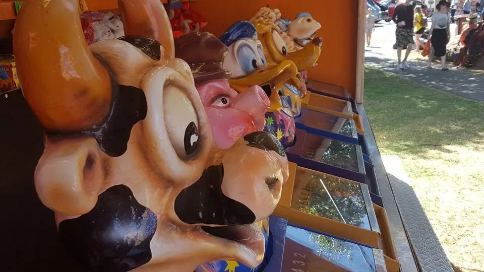 Carnival prize display with cartoon cow and animal figures