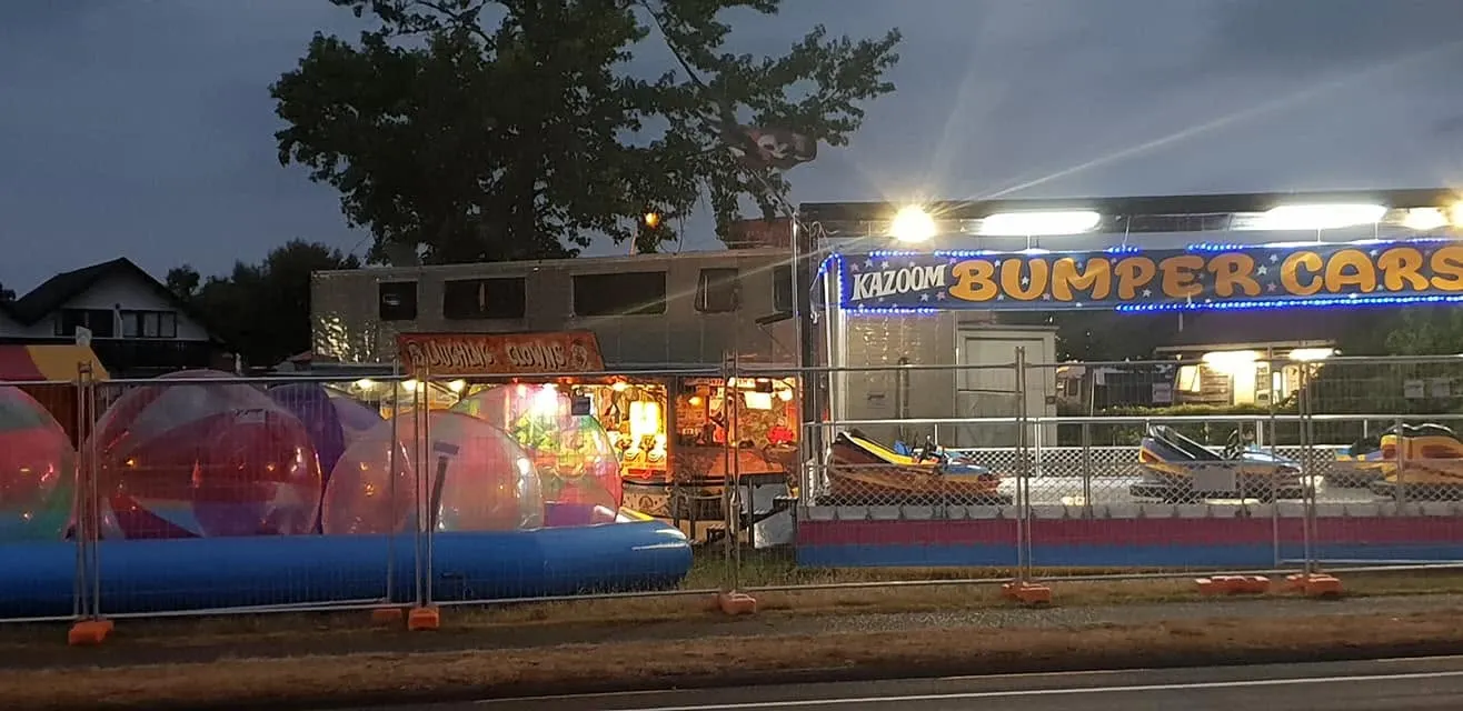 Bumper car arena and stalls lit up at night