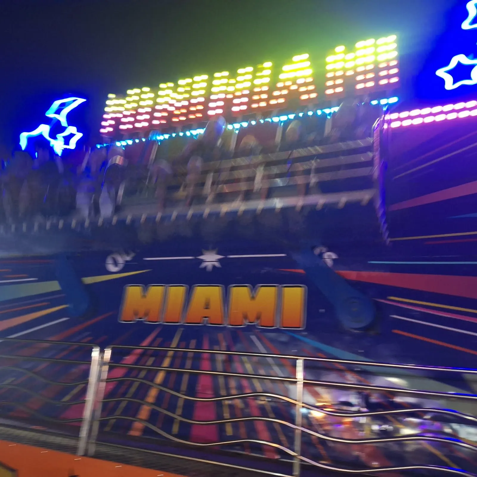Mini Miami ride lit with neon lights at night
